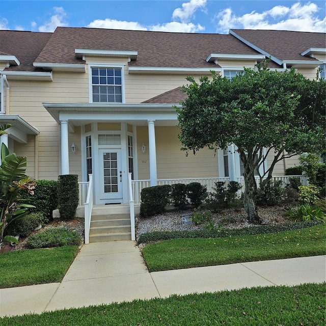 view of front facade featuring roof with shingles