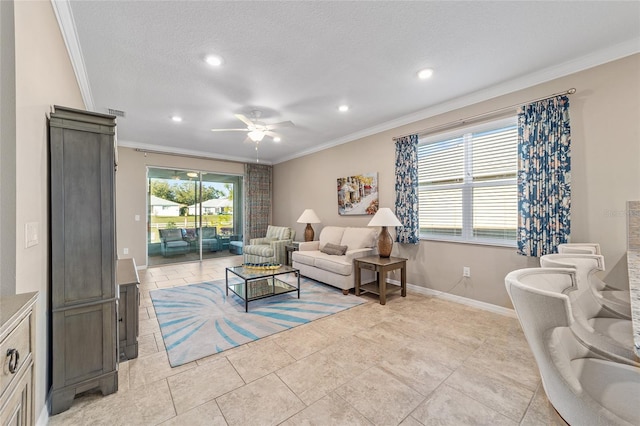 living room featuring a ceiling fan, plenty of natural light, ornamental molding, and baseboards