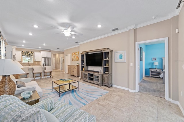 living room with baseboards, a ceiling fan, visible vents, and crown molding