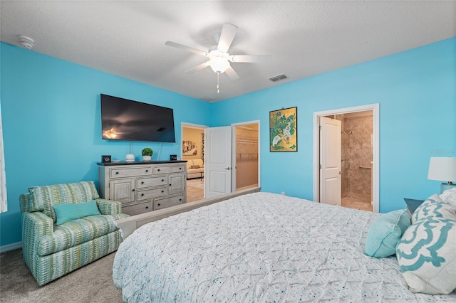 bedroom with a ceiling fan, light colored carpet, visible vents, and a textured ceiling