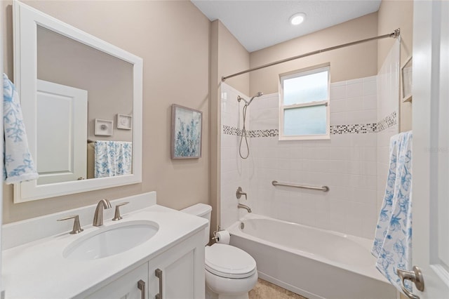 bathroom featuring toilet, shower / tub combination, and vanity