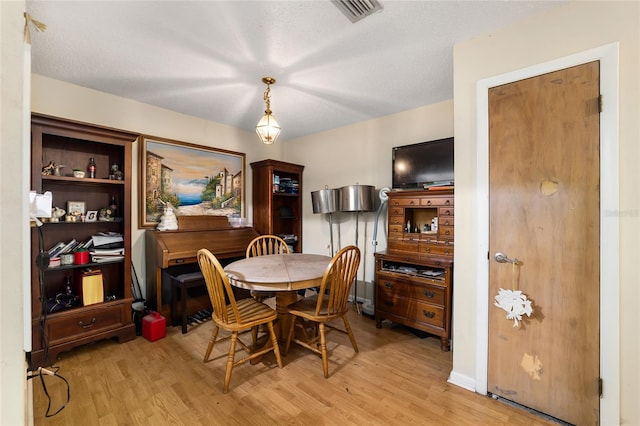 dining room featuring visible vents and light wood finished floors