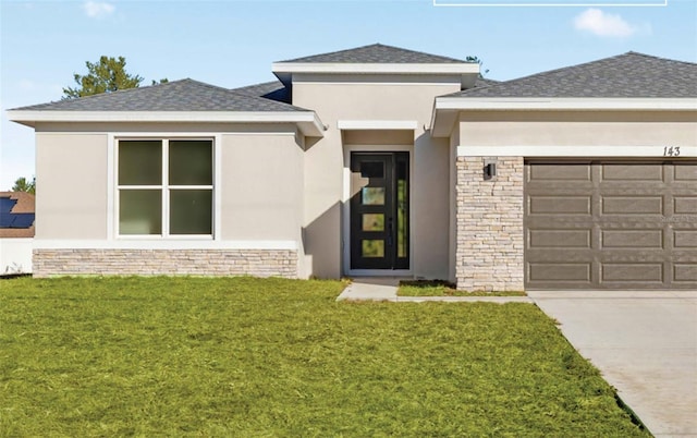 view of exterior entry with a garage, a yard, driveway, roof with shingles, and stucco siding