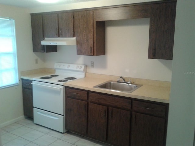 kitchen featuring under cabinet range hood, electric range, light countertops, and a sink