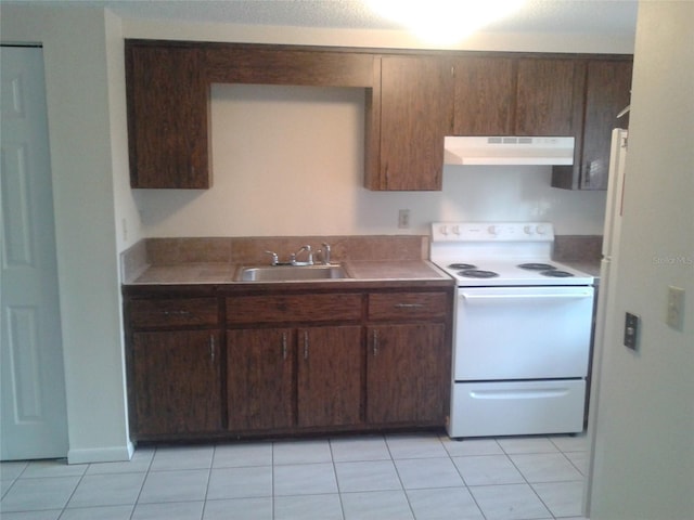 kitchen with electric stove, light tile patterned flooring, a sink, and under cabinet range hood