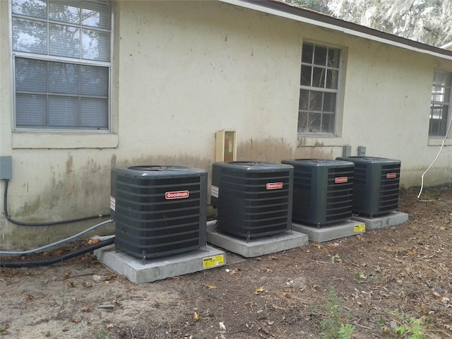 details featuring central AC unit and stucco siding