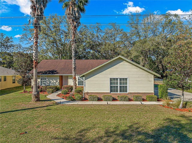 view of front of property with a front lawn and brick siding