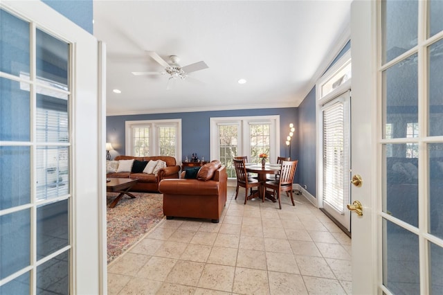 living area featuring baseboards, a ceiling fan, crown molding, french doors, and recessed lighting