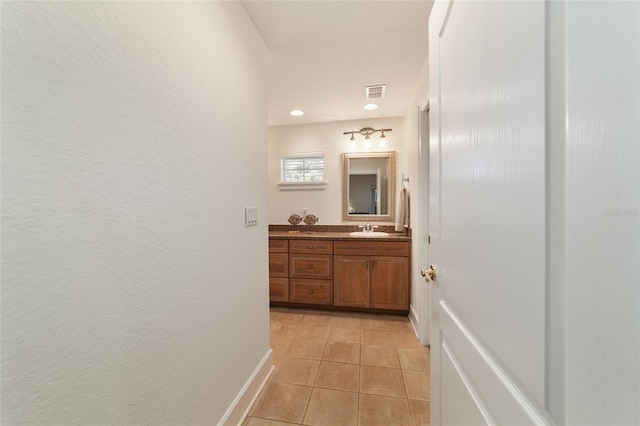 bathroom with tile patterned flooring, visible vents, baseboards, and vanity