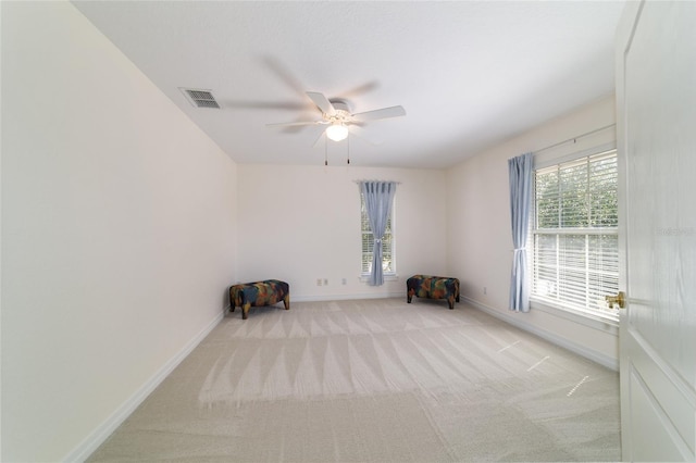 unfurnished room with carpet floors, ceiling fan, visible vents, and baseboards