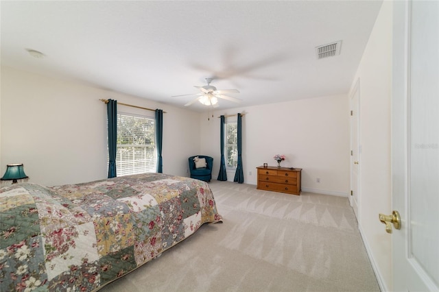 carpeted bedroom with ceiling fan, visible vents, and baseboards