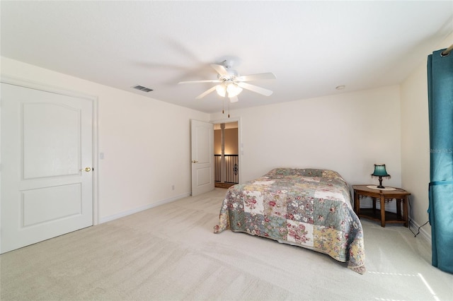 bedroom featuring baseboards, carpet floors, visible vents, and a ceiling fan