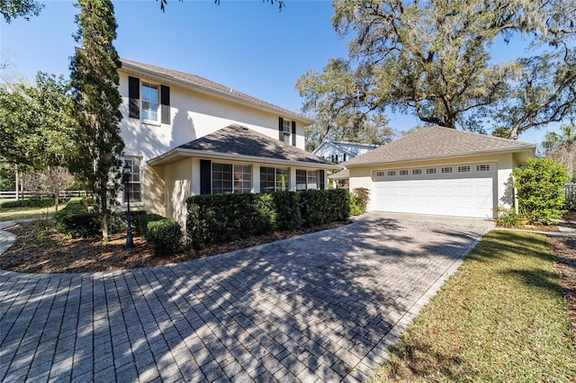 traditional-style home with an outbuilding, fence, and stucco siding