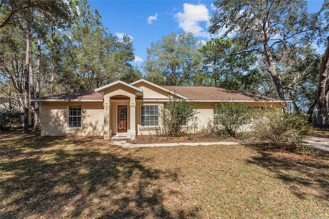 single story home with a front lawn and stucco siding