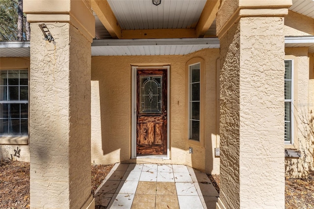 doorway to property with stucco siding