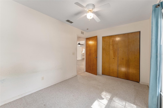 unfurnished bedroom with ceiling fan, a closet, and visible vents