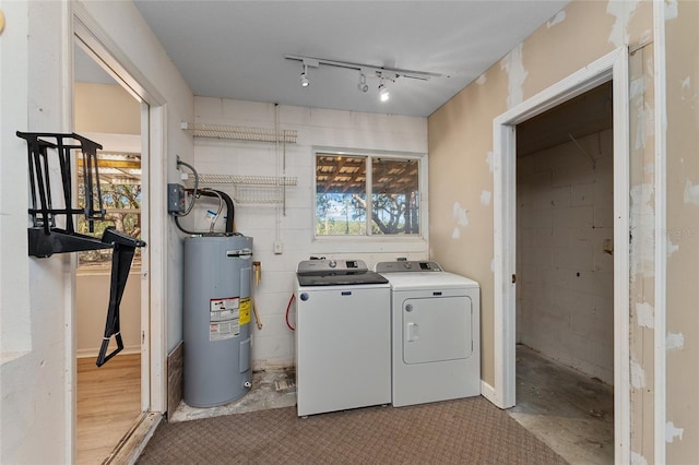 washroom with water heater, laundry area, track lighting, and washer and dryer