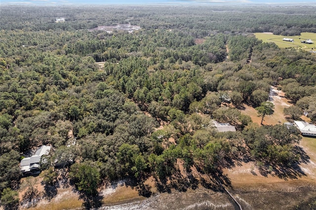 birds eye view of property with a forest view