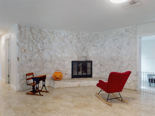 sitting room featuring a fireplace and visible vents