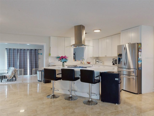 kitchen with white cabinets, island range hood, stainless steel refrigerator with ice dispenser, and light countertops