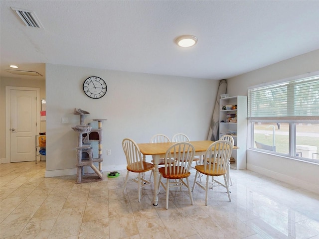 dining space featuring visible vents and baseboards