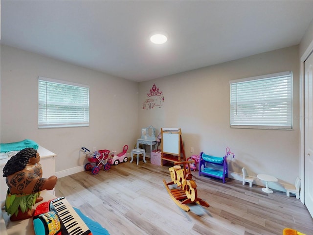 recreation room featuring light wood-type flooring and baseboards