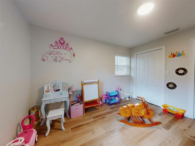 recreation room with visible vents and wood finished floors