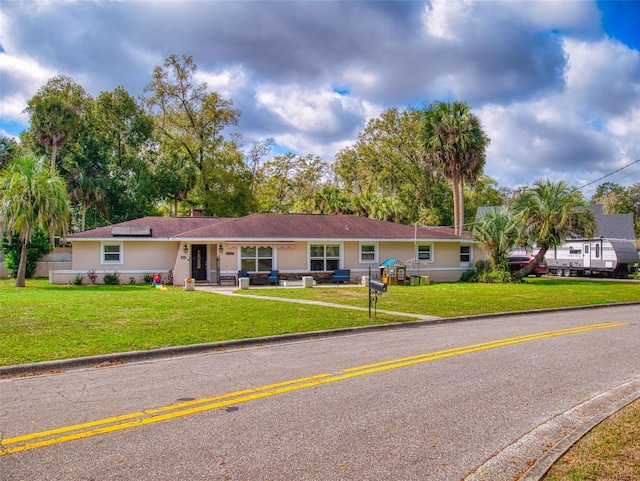 single story home featuring a front yard and stucco siding