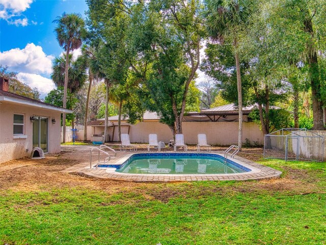 view of swimming pool featuring a yard, fence, a fenced in pool, and a gazebo