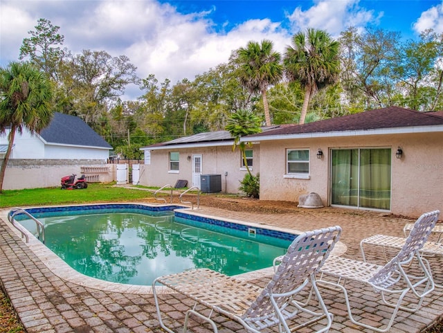 view of swimming pool featuring cooling unit, a fenced backyard, and a fenced in pool