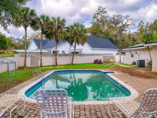 view of pool featuring a patio, central AC unit, fence, and a fenced in pool