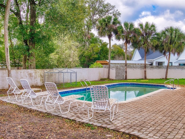 view of pool with a patio, a fenced backyard, and a fenced in pool