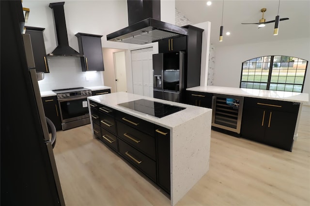 kitchen with appliances with stainless steel finishes, a kitchen island, island range hood, beverage cooler, and wall chimney exhaust hood