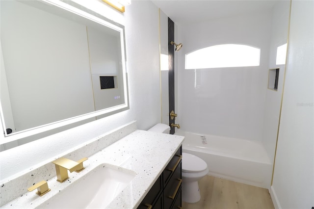 full bath with shower / bathing tub combination, vanity, toilet, and wood finished floors