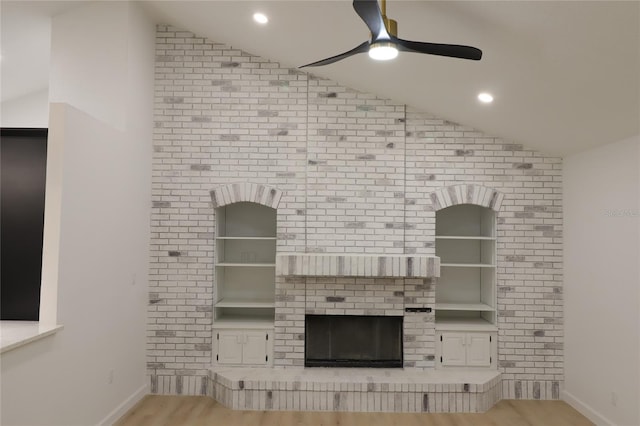 unfurnished living room with lofted ceiling, light wood-type flooring, a ceiling fan, and recessed lighting