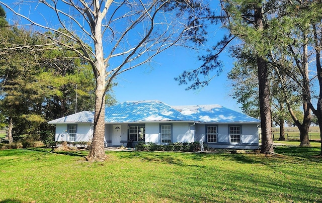 single story home with stucco siding and a front yard