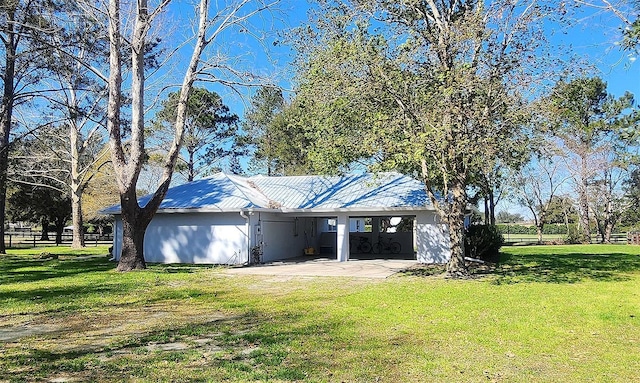 exterior space with driveway, fence, an attached carport, and a yard