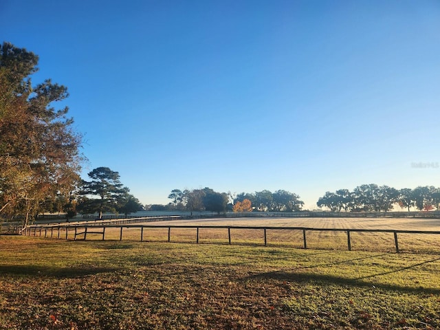 view of yard featuring a rural view and fence