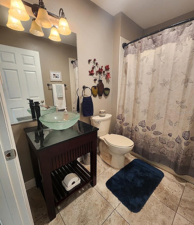 bathroom featuring tile patterned flooring, vanity, and toilet