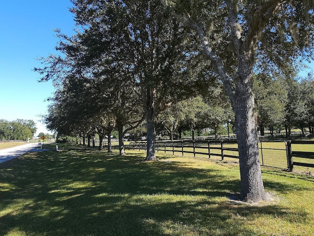 view of yard with a rural view and fence