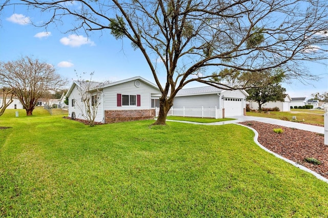 view of front facade with a garage, concrete driveway, brick siding, and a front yard