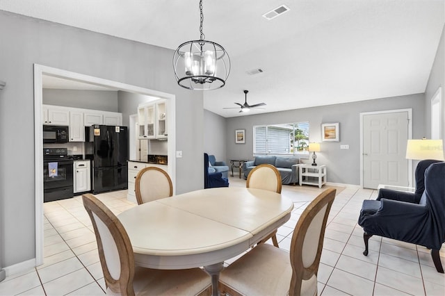 dining area featuring light tile patterned floors, ceiling fan with notable chandelier, lofted ceiling, and visible vents