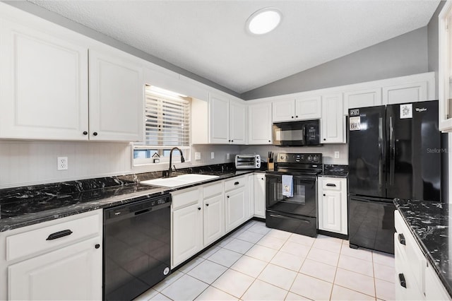 kitchen featuring black appliances, dark stone countertops, a sink, and white cabinets