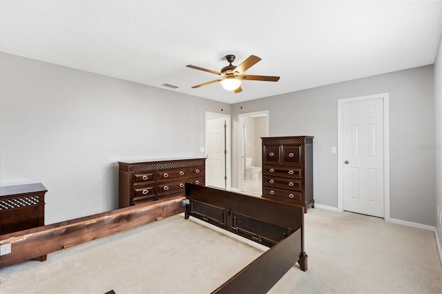 bedroom with a textured ceiling, light carpet, a ceiling fan, visible vents, and baseboards