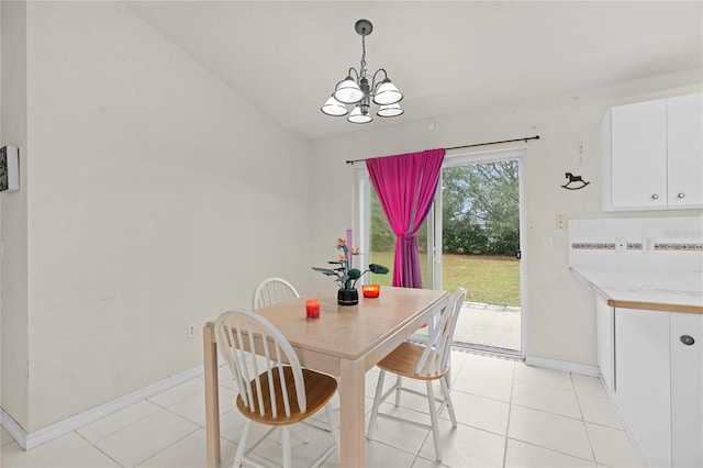 dining space featuring baseboards, light tile patterned floors, and an inviting chandelier