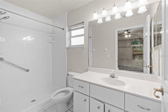 full bathroom with toilet, a textured wall, a shower stall, and vanity