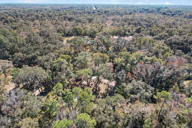 drone / aerial view featuring a wooded view