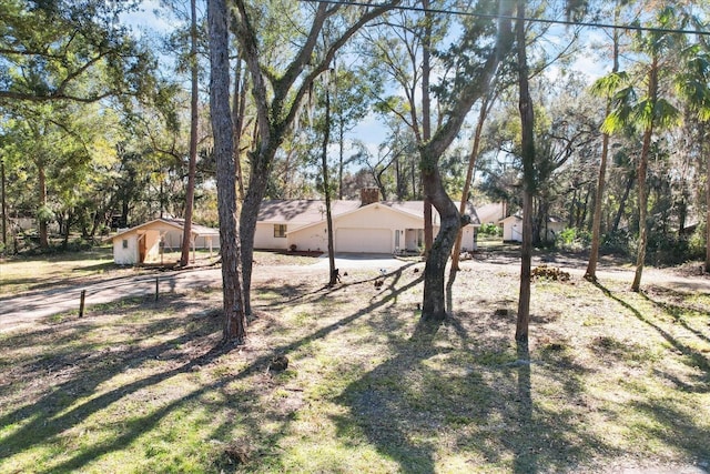 view of yard with driveway and an attached garage