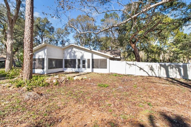 rear view of property with fence