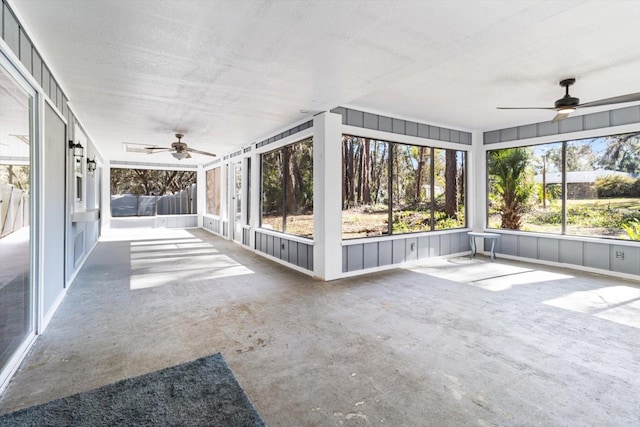 unfurnished sunroom with ceiling fan